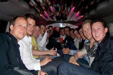A large group of people sitting inside a limousine